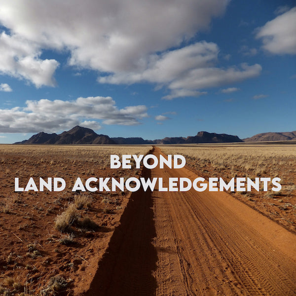 View of the desert with the phrase "Beyond Land Acknowledgements"